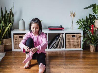 Child putting socks on.