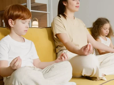 Family meditating on couch.