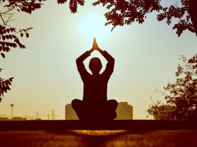 Person meditating during daytime.