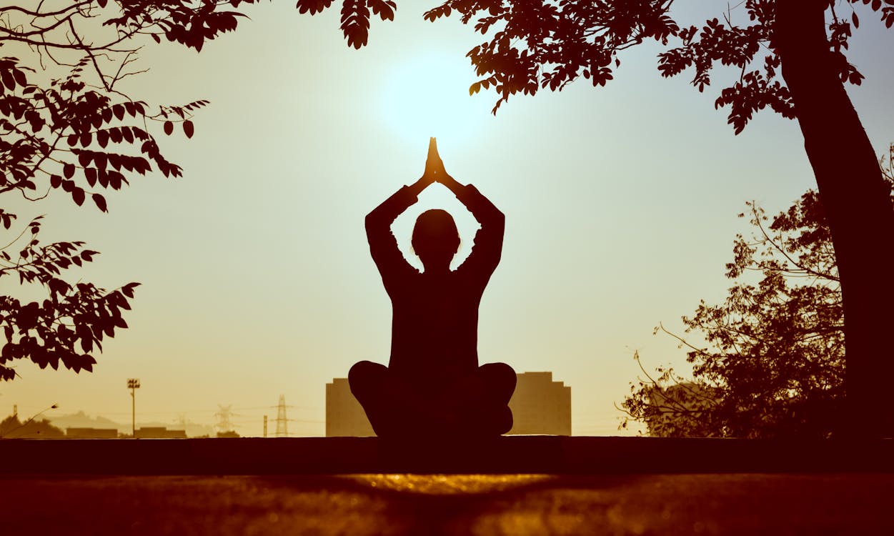 Person meditating during daytime.