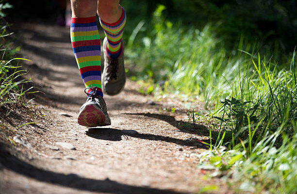 Person jogging on a dirt trail.