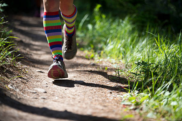 Person jogging on a dirt trail.