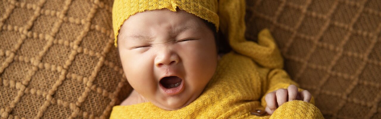 A woman dressed in yellow pajamas yawning