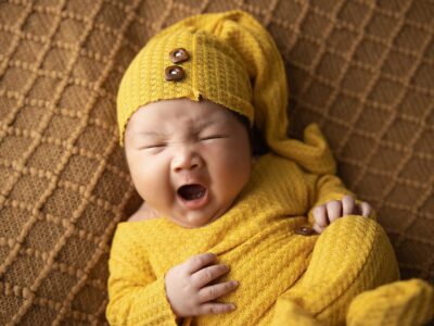 A woman dressed in yellow pajamas yawning