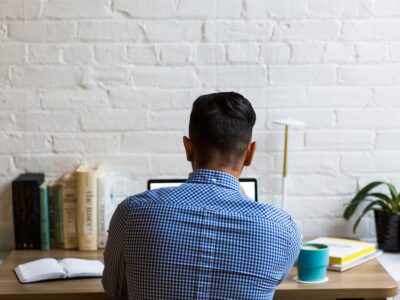 Sitting man looking at his laptop.