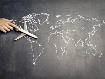 Airplane figurine on a map of the world.