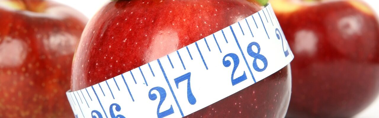 Measuring tape around an apple.