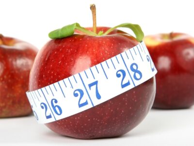 Measuring tape around an apple.