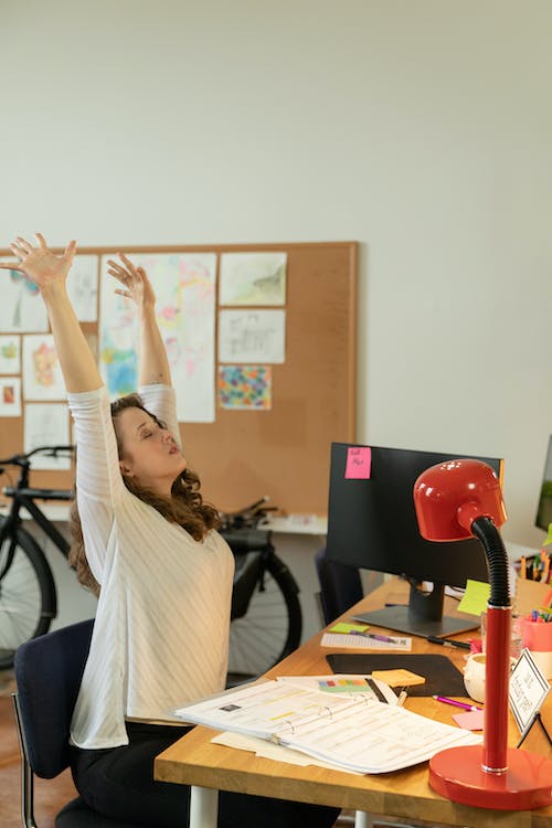 Woman stretching at her desk,