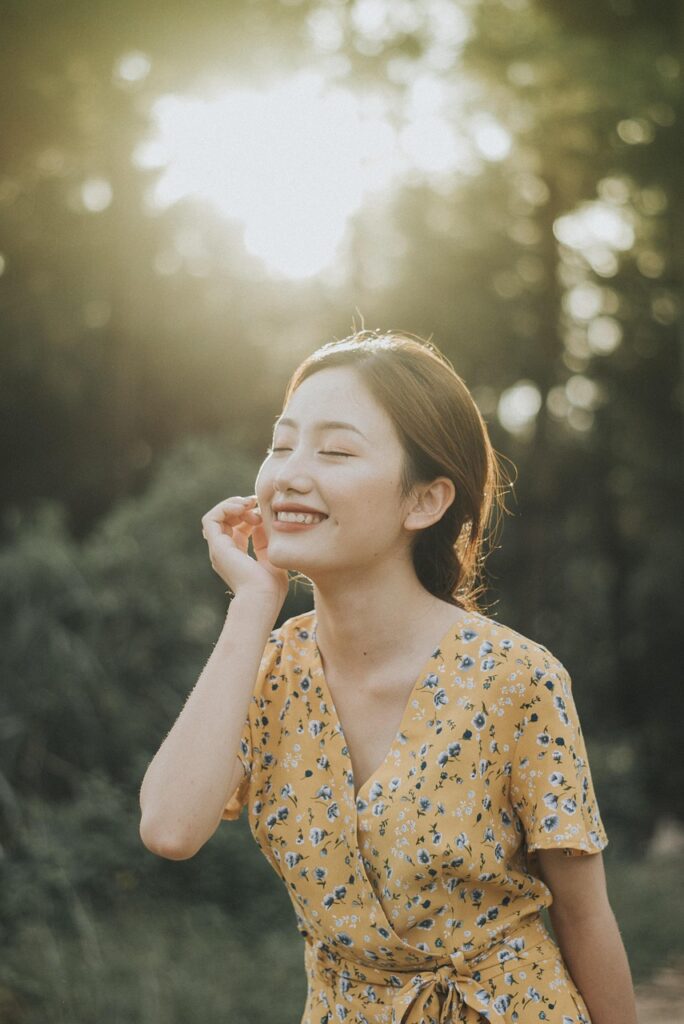 A woman in nature smiling. 