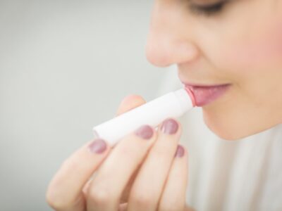 A person putting on chapstick.