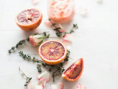 Citrus and dried flowers spread out on white counter