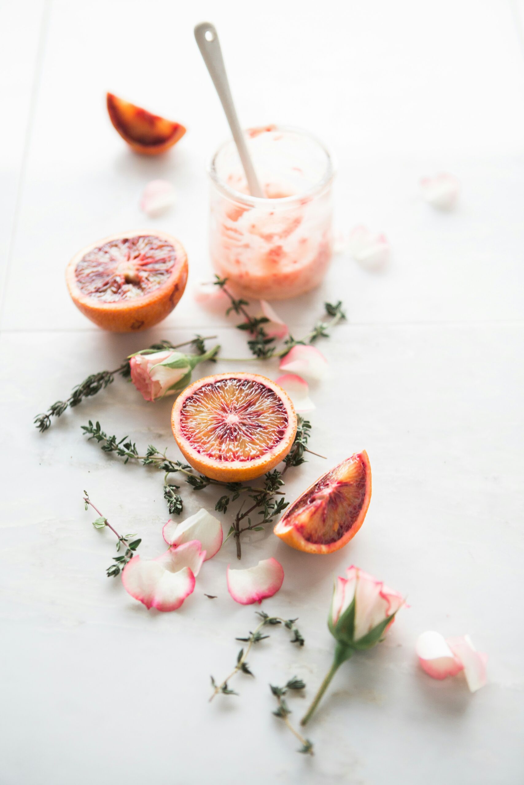 Citrus and dried flowers spread out on white counter