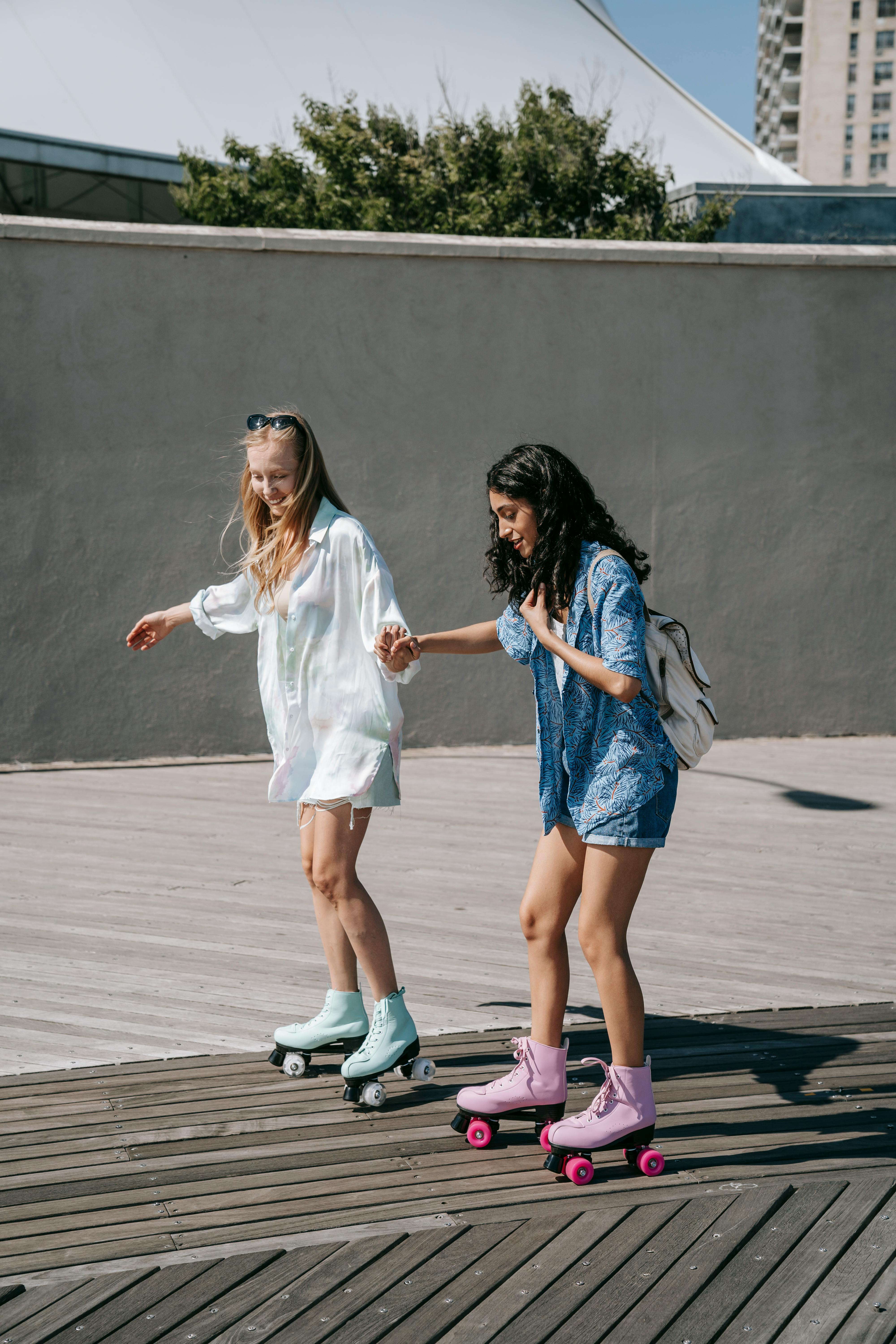 One woman helping another women skating