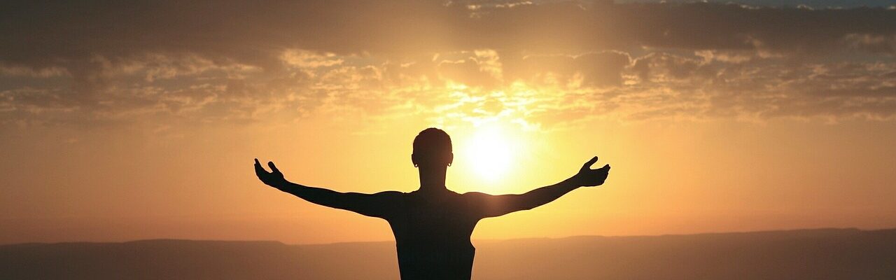 Woman in front of sunrise.